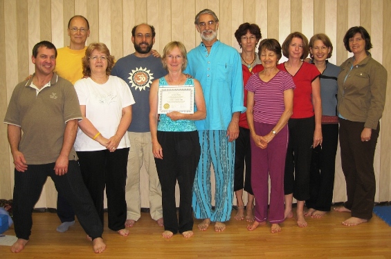 A group of Yoga Teacher Trainess celebrates With Matt and Larry when Chris Rigby receiving her Yoga Teacher Certification